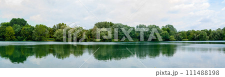 Panoramic view of beautiful lake in park. Landscape with lake, green trees 111488198