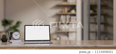 A tabletop with a white-screen laptop for displaying your graphic ads on the screen in a modern room A tabletop with a white-screen laptop for displaying your graphic ads on the screen in a modern room 111489681