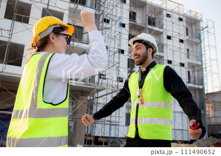 Happy team of architect or engineer with success and glad at construction site. Happy team of architect or engineer with success and glad at construction site. 111490652