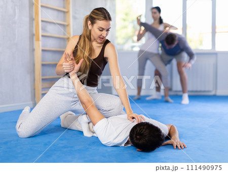 Couples self-defense training - a woman learns to seize power against male attacker Couples self-defense training - a woman learns to seize power against male attacker 111490975