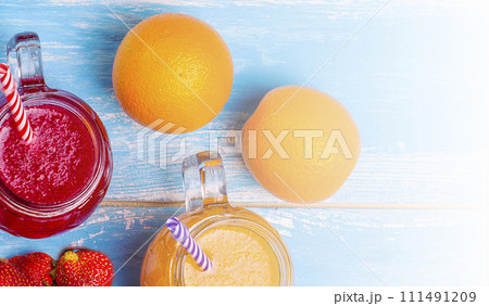 Fresh strawberry and orange cocлtailes with fruits on a wooden rustic background. Fresh strawberry and orange cocлtailes with fruits on a wooden rustic background. 111491209