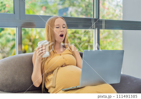 Tired pregnant woman at work drinks coffee caution advised due to potential harm of caffeine during pregnancy Tired pregnant woman at work drinks coffee caution advised due to potential harm of caffeine during pregnancy 111491385