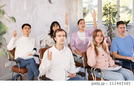 Young male student diligently attending lesson in college 111493385