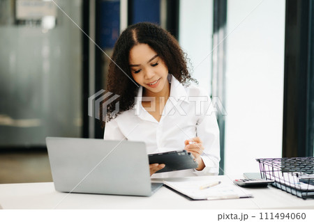 Confident business expert attractive smiling young woman holding digital tablet . Confident business expert attractive smiling young woman holding digital tablet . 111494060