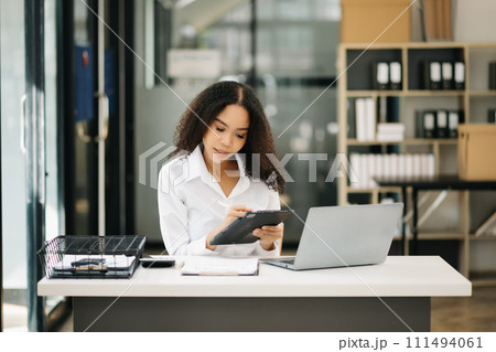 Confident business expert attractive smiling young woman holding digital tablet . Confident business expert attractive smiling young woman holding digital tablet . 111494061