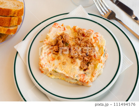 Delicious Russian salad topped with minced canned tuna 111494576