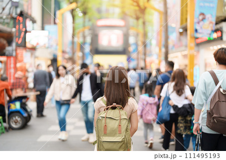 woman traveler visiting in Taiwan, Tourist with bag sightseeing and Shopping in Ximending street Market, landmark and popular attractions in Taipei city. Asia Travel and Vacation concept 111495193