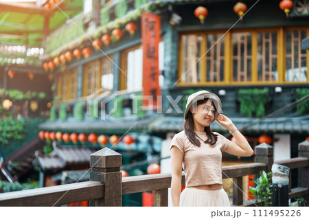 woman traveler visiting in Taiwan, Tourist with hat sightseeing in Jiufen Old Street village with Tea House background. landmark and popular attractions near Taipei city . Travel and Vacation concept woman traveler visiting in Taiwan, Tourist with hat sightseeing in Jiufen Old Street village with Tea House background. landmark and popular attractions near Taipei city . Travel and Vacation concept 111495226