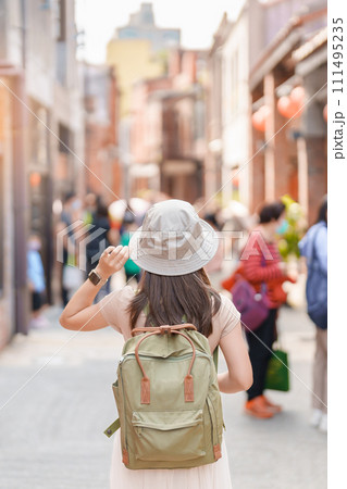 woman traveler visiting in Taiwan, Tourist with backpack and hat sightseeing in Bopiliao Historic Block, landmark and popular attractions in Taipei city. Asia Travel woman traveler visiting in Taiwan, Tourist with backpack and hat sightseeing in Bopiliao Historic Block, landmark and popular attractions in Taipei city. Asia Travel 111495235