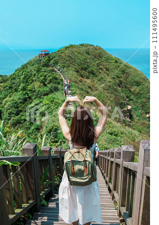 woman traveler visiting in Taiwan, Tourist with backpack sightseeing in Bitou Cape Hiking Trail, New Taipei City. landmark and popular attractions near Taipei. Asia Travel concept woman traveler visiting in Taiwan, Tourist with backpack sightseeing in Bitou Cape Hiking Trail, New Taipei City. landmark and popular attractions near Taipei. Asia Travel concept 111495600