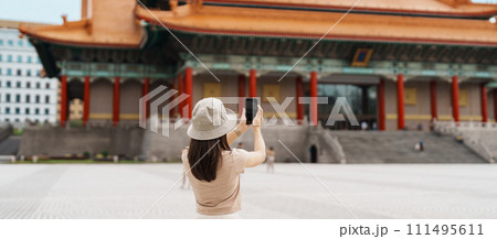 woman traveler visiting in Taiwan, Tourist taking photo and sightseeing in National Chiang Kai shek Memorial or Hall Freedom Square, Taipei City. landmark and popular attractions. Asia Travel concept woman traveler visiting in Taiwan, Tourist taking photo and sightseeing in National Chiang Kai shek Memorial or Hall Freedom Square, Taipei City. landmark and popular attractions. Asia Travel concept 111495611