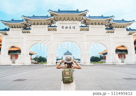 woman traveler visiting in Taiwan, Tourist with backpack sightseeing in National Chiang Kai shek Memorial or Hall Freedom Square, Taipei City. landmark and popular attractions. Asia Travel concept 111495612