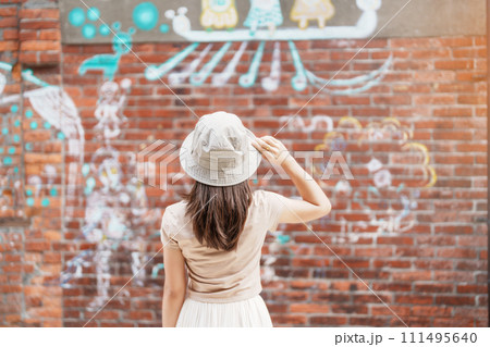 woman traveler visiting in Taiwan, Tourist with backpack and hat sightseeing in Bopiliao Historic Block, landmark and popular attractions in Taipei city. Asia Travel woman traveler visiting in Taiwan, Tourist with backpack and hat sightseeing in Bopiliao Historic Block, landmark and popular attractions in Taipei city. Asia Travel 111495640