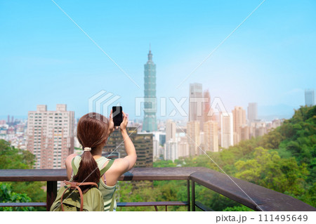 woman traveler visiting in Taiwan, Tourist looking Taipei City during sightseeing and hiking at Elephant Mountain or Xiangshan, landmark and popular attractions. Asia Travel, vacation and Trip concept 111495649