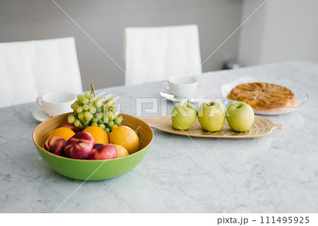 Plate of ripe fruits on a table 111495925