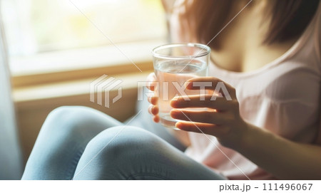 Close-up, Young woman drinking water, Woman enjoying a refreshing beverage at home, Generative AI Close-up, Young woman drinking water, Woman enjoying a refreshing beverage at home, Generative AI 111496067