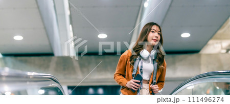 Young asian woman in international airport terminal or modern train station Young asian woman in international airport terminal or modern train station 111496274