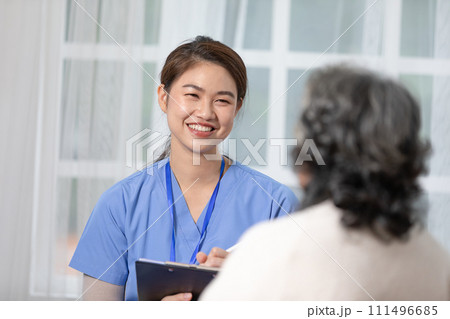 Asian doctor woman visited senior or elderly patient to diagnosis and check up health at home.Happy elderly enjoy cheerful with doctor or nurse on couch.Health care premium service at home Asian doctor woman visited senior or elderly patient to diagnosis and check up health at home.Happy elderly enjoy cheerful with doctor or nurse on couch.Health care premium service at home 111496685
