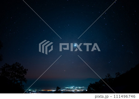 travel and people activity concept with star in the night with tree on mountain and lighting of city background 111496746