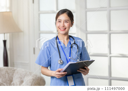 Asian female doctor with a stethoscope smile looking at camera.Nurses wear scrub smile with heartwarming comfortable.Positive emotional and good moment.Health Care Concept Asian female doctor with a stethoscope smile looking at camera.Nurses wear scrub smile with heartwarming comfortable.Positive emotional and good moment.Health Care Concept 111497000