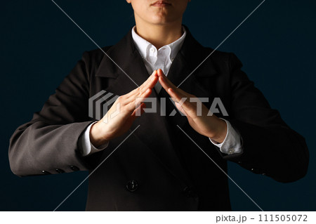 Businessman's hand close-up on a dark background Businessman's hand close-up on a dark background 111505072