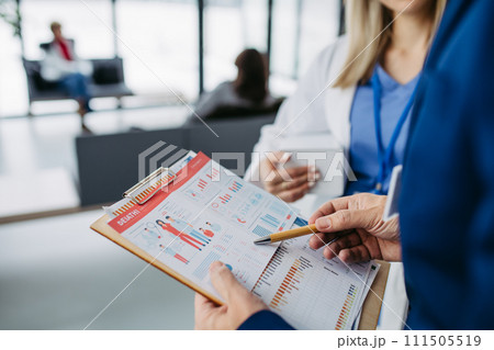 Rear view of pharmaceutical sales representative talking with doctor in medical building. Ambitious male sales representative presenting new medication. 111505519