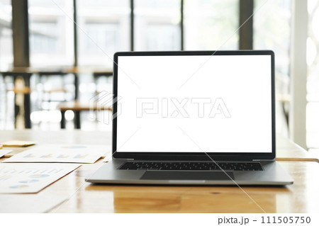 Blank screen laptop computer mockup on table in modern office. Blank screen laptop computer mockup on table in modern office. 111505750