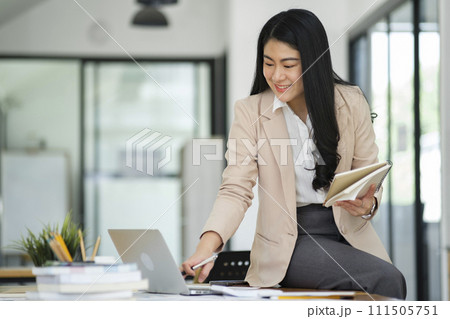 Businesswoman Analyzing Data on Laptop in Office. Businesswoman Analyzing Data on Laptop in Office. 111505751