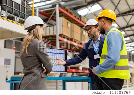 Engineer, foreman consulting with director in modern industrial factory, talking about new production project or investment. Team management in manufacturing facility. 111505767