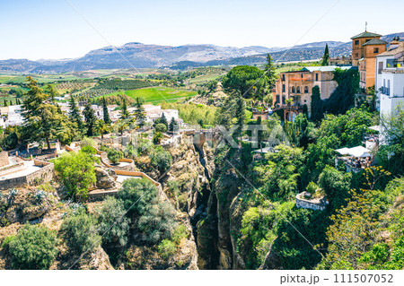 Ronda, Spain. Aerial evening view of New Bridge over Guadalevin River in Ronda, Andalusia, Spain. View of the touristic city. Ronda, Spain. Aerial evening view of New Bridge over Guadalevin River in Ronda, Andalusia, Spain. View of the touristic city. 111507052