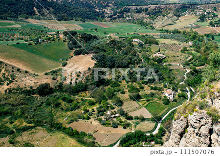 Ronda town and valley, Andalusia, Spain. Popular landmark. Tourist attraction at sunset light, place to visit. View from the city on valley 111507076