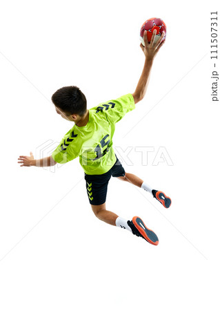 Top view image of young guy, handball player in motion during game playing, training against white studio background Top view image of young guy, handball player in motion during game playing, training against white studio background 111507311
