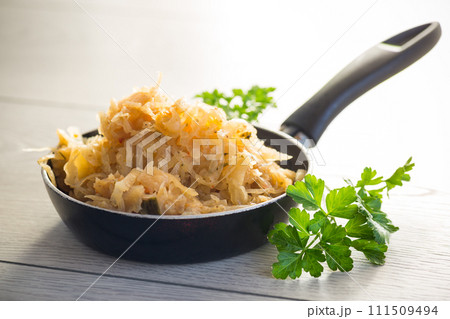cabbage stewed with spices and carrots in a frying pan , cabbage stewed with spices and carrots in a frying pan , 111509494