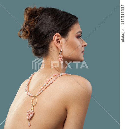 Lovely jewelry model. Woman back with bijou sautoir rope necklace close up Lovely jewelry model. Woman back with bijou sautoir rope necklace close up 111511337