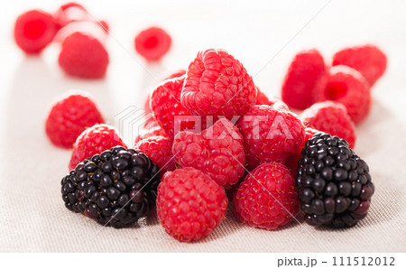 Handful of fresh raspberry and blackberry berries on white background 111512012