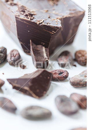 Cocoa beans with chocolate on a white background. Shalllow dof. 111513068