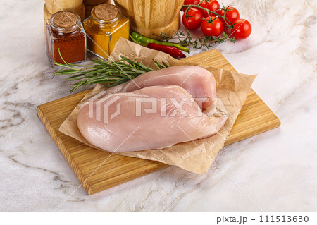Raw chicken breast served rosemary 111513630
