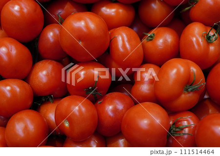 Tomatoes lying on a pile on top of each other, tomato texture. Selective focus. Tomatoes lying on a pile on top of each other, tomato texture. Selective focus. 111514464