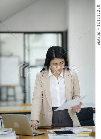 Businesswoman Analyzing Data on Laptop in Office. Businesswoman Analyzing Data on Laptop in Office. 111515250