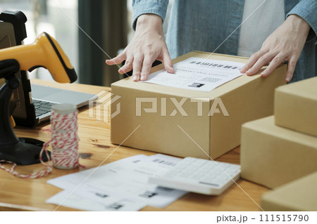 Scanning Barcode on Shipping Box with Scanner 111515790