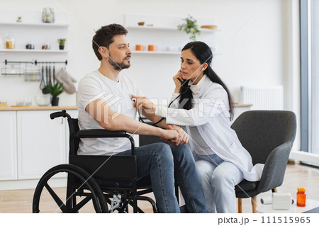 General practitioner examining heartbeat while providing regular checkup at home General practitioner examining heartbeat while providing regular checkup at home 111515965