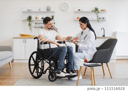Man in wheelchair listening about necessity of leading healthy lifestyle. Man in wheelchair listening about necessity of leading healthy lifestyle. 111516028