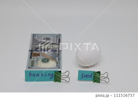Dollar bills inserted into the radiator slots of  heating system, the increase in the cost of heat 111516737