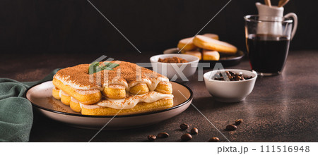 Tiramisu classic dessert with cookies, mascarpone and coffee on a plate web banner 111516948