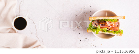 Toast sandwich with ham, cheese and herbs in a bowl on the table top view web banner 111516956