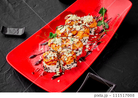 Sushi rolls with seared cheese and seafood caps sprinkled with parmesan Sushi rolls with seared cheese and seafood caps sprinkled with parmesan 111517008