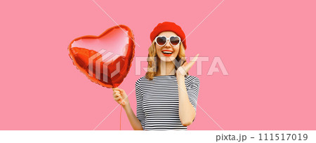 Cute portrait of happy cheerful smiling woman with red heart shaped balloon 111517019