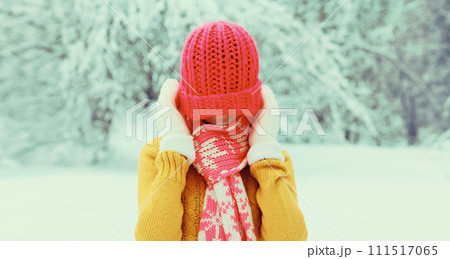 Winter portrait of happy cheerful young woman having fun enjoys weather in snowy park Winter portrait of happy cheerful young woman having fun enjoys weather in snowy park 111517065