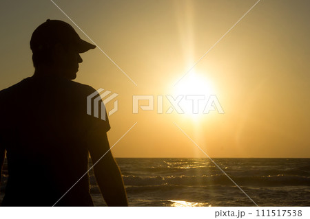 Portrait of a young man in cap on the beach Portrait of a young man in cap on the beach 111517538