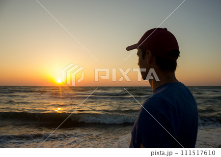 Portrait of a young man in cap on the beach 111517610